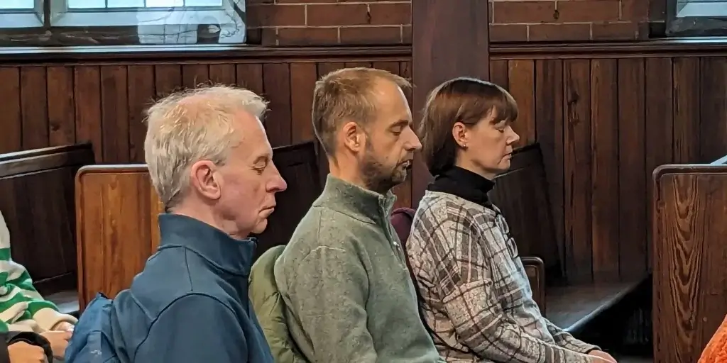 Two men and a woman peacefully meditating at Vajrapani Kadampa meditation centre
