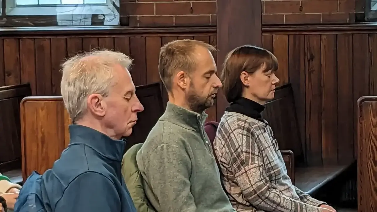 Two men and a woman peacefully meditating at Vajrapani Kadampa meditation centre