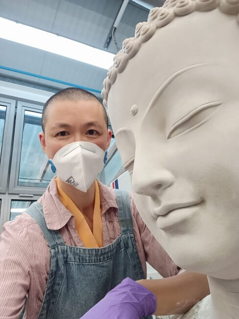 Serene Buddha statue face with Gen Varahi ( ordained Buddhist teacher)