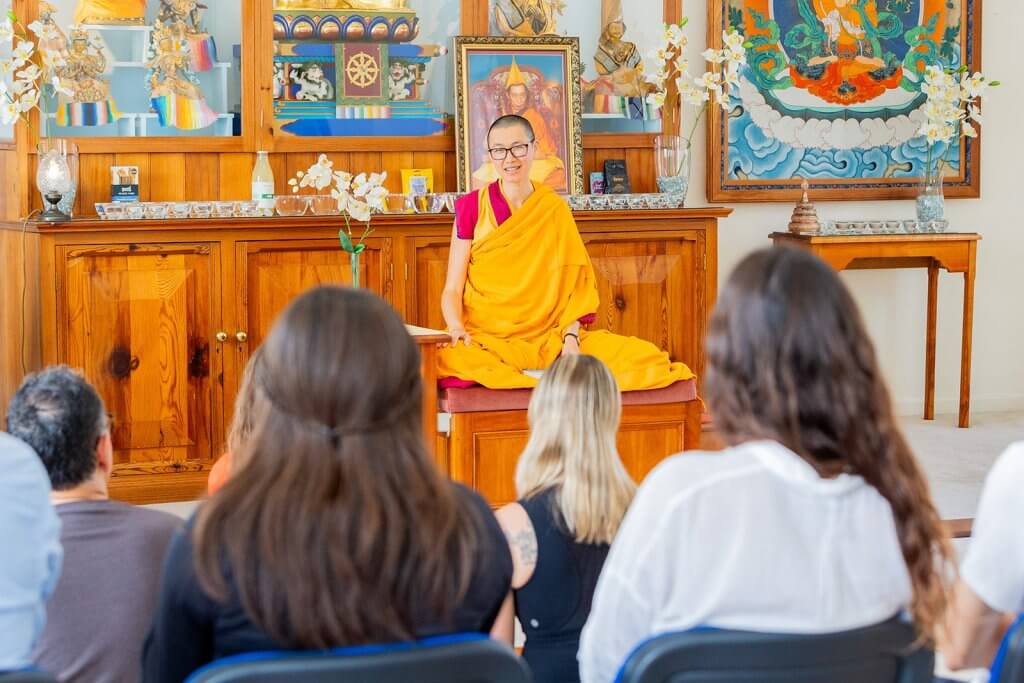 Buddhist nun Kelsang Varahi in traditional robes teaching a Buddhist meditation class