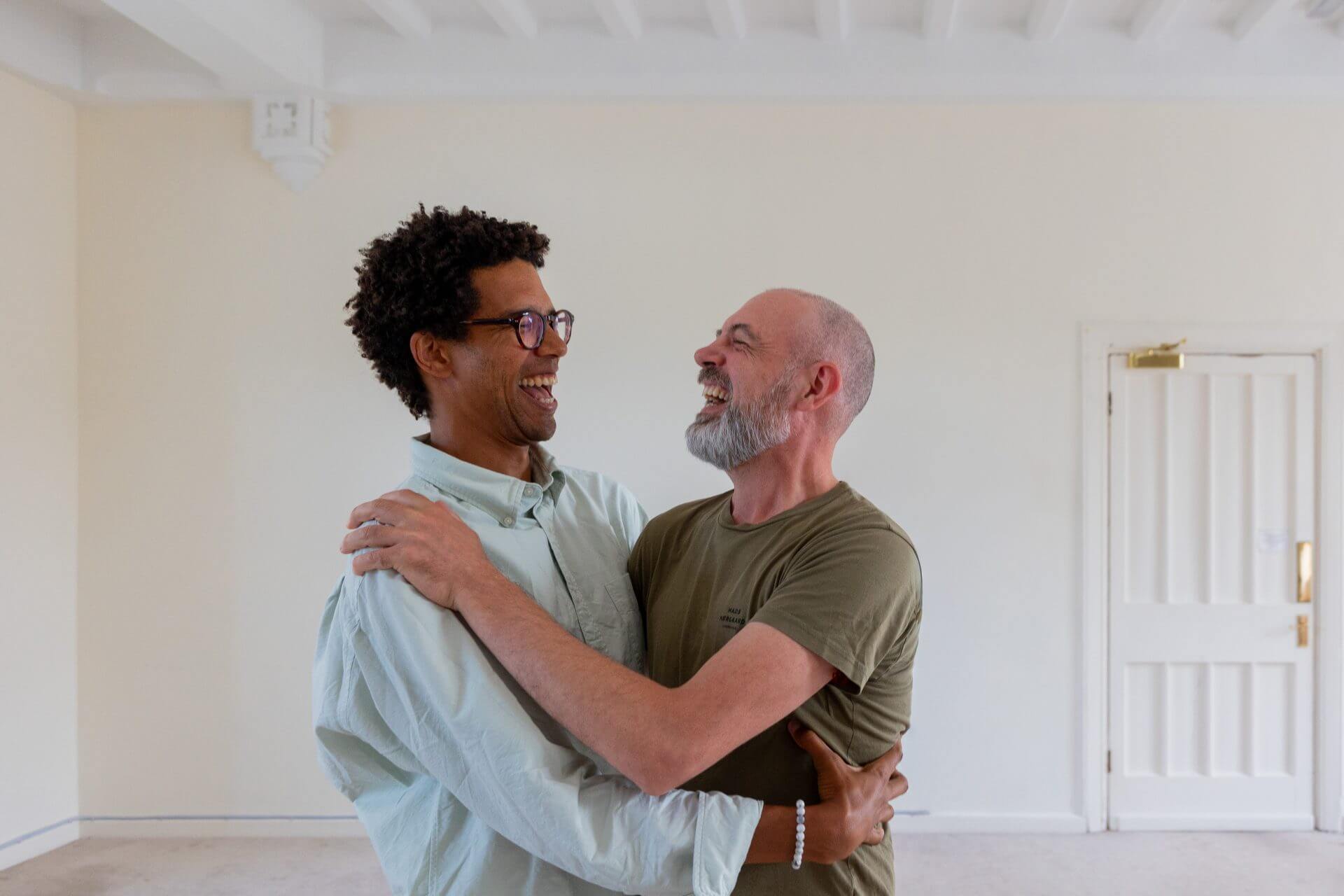 Two people hugging and smiling at each other