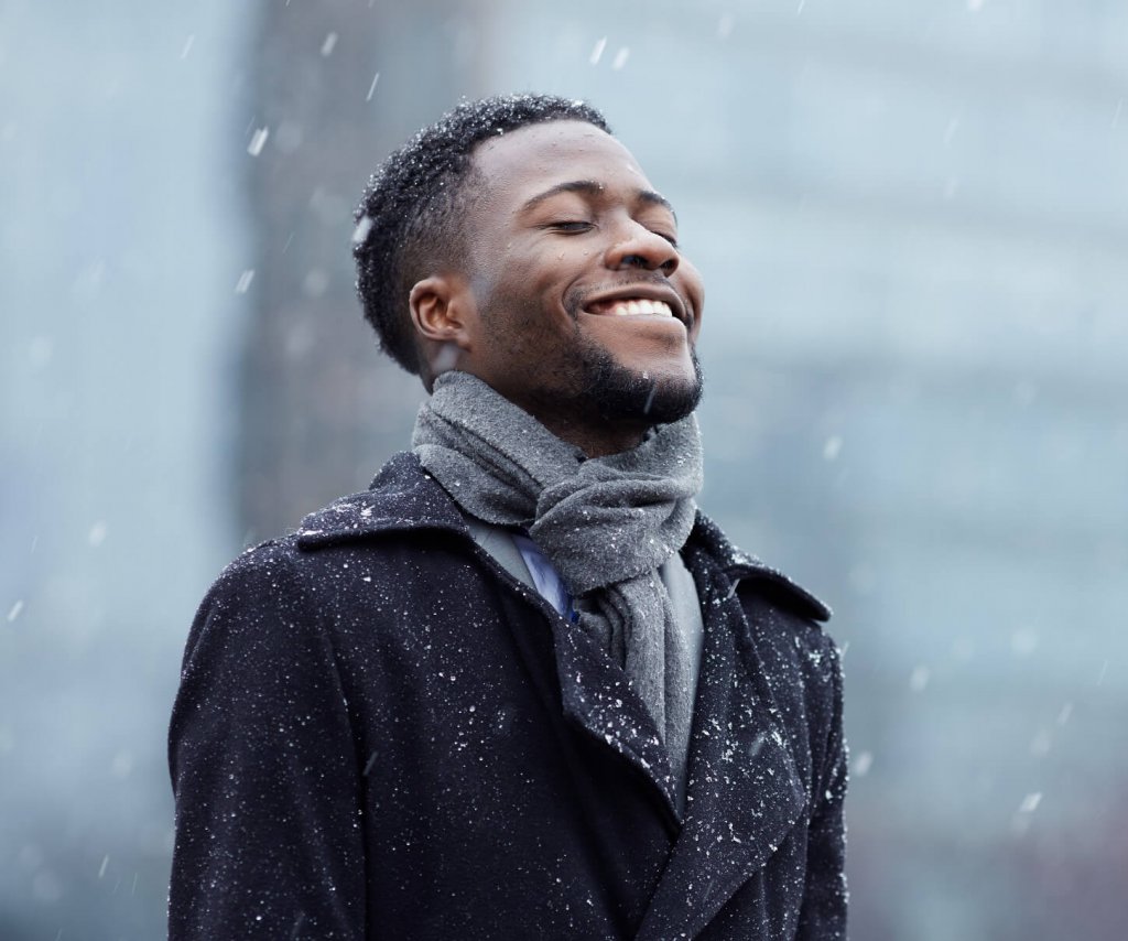 A man smiling in the rain
