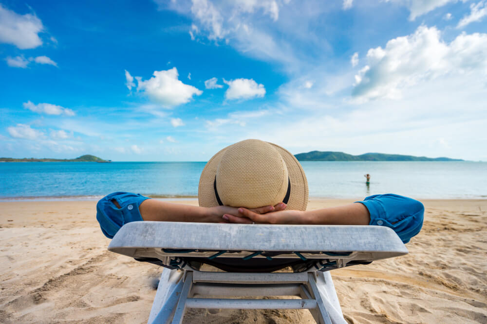 someone looking out on to a beautiful beach looking very relaxed and laid back